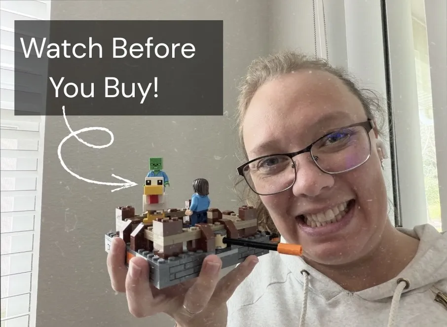 Amber holding up an assembled Lego Minecraft set.